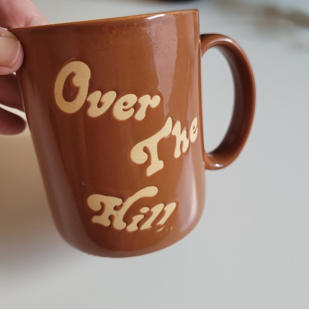 Vintage Russ Brown Ceramic Mug with Cream Text Over The Hill